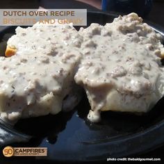 two pieces of meat covered in gravy on a black plate with the words dutch oven recipe biscuit and gravy