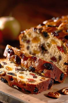 a loaf of fruit bread sitting on top of a cutting board