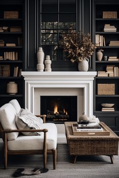 a living room with a fire place and bookshelves on the wall behind it