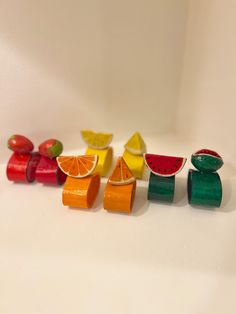 several pieces of fruit are arranged in the shape of fruits on a white table top