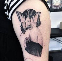 a woman with a butterfly tattoo on her arm