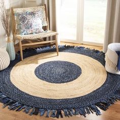 a living room with a chair and rug on the floor