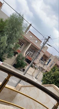 the view from inside a vehicle looking at an apartment building with stairs leading up to it