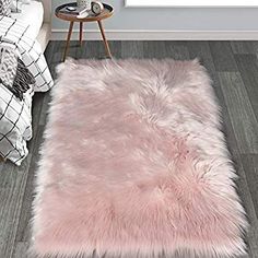 a pink rug on the floor in a bedroom