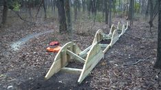 a wooden bench sitting in the middle of a forest