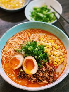 a bowl of ramen with boiled eggs and vegetables