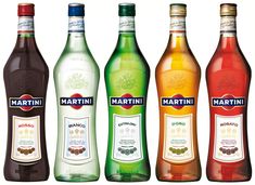 three bottles of martini are lined up next to each other in front of a white background