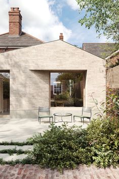 two chairs sitting on top of a brick patio