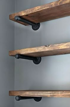 three wooden shelves with black pipe handles