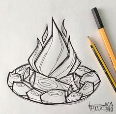 a drawing of a fire pit with pencils next to it