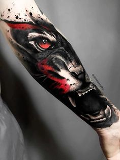 a man's arm with a black and red tiger tattoo on the left forearm