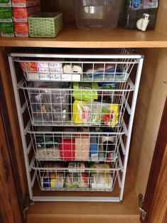 the pantry is stocked with food and containers for storage, including milks, juices, and condiments