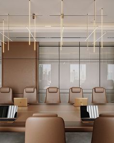 an empty conference room with chairs and laptops on the table in front of them