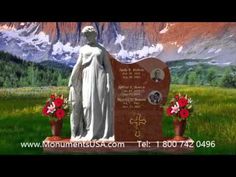 a statue in the middle of a field with mountains in the background and flowers around it