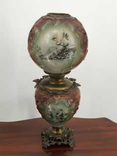 two vases sitting on top of a wooden table next to each other with designs on them