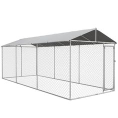 a large metal dog kennel with a white roof and chain link fence around it