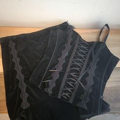 Please note, my camera doesn't photograph black garments very well. I know the images aren't great. If you need to see more images, please do not hesitate to ask.  This is a vintage Tripp NYC, stretch, corset style, sleeveless, top and corset style skirt, set. They are stretch, black velvet and black lace trim. The straps on the top can unbutton and be removed. Both the skirt and top have ribbon lacing, but this is decorative and not meant for tightening. The top and bottom both have zippers. This set is a size XL. There are 4 areas on the waistband that have marks from skirt hangers. This set has been worn and shows some signs of wear. There is some minor white in one armpit. You can see all this in the images. All sales are final.  The measurements are as follows: All measurements taken Tripp Nyc Top, Esoteric Clothes, Romantic Goth Fashion, Tripp Nyc Skirt, Corset Over Dress, Vintage Tripp Nyc, Dream Skirt, Black Lace Corset Top, Purple Goth