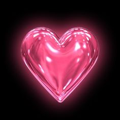 a pink heart shaped object in the middle of a black background with light shining on it