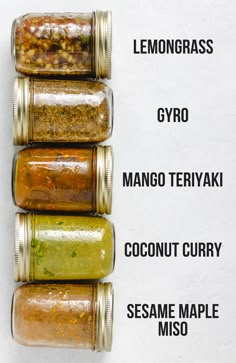 four jars filled with different kinds of food on top of a white surface, labeled lemongrass gyro mango teriyaki coconut curry sesame maple miso