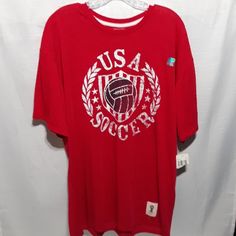 a red shirt with the usa soccer logo on it