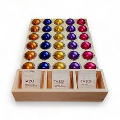 an assortment of taco chocolates in a wooden box on a white background with tags