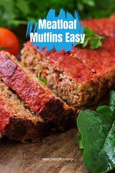 meatloaf muffins are cut into slices on a cutting board with greens