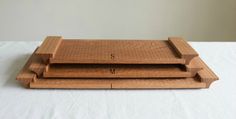 two wooden trays sitting on top of a white tablecloth covered surface with the letters s and w