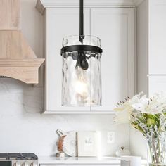 a glass light hanging over a kitchen counter