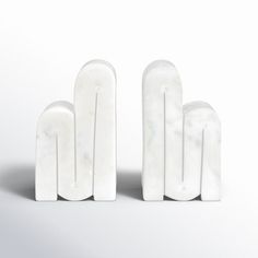 three white marble sculptures sitting next to each other