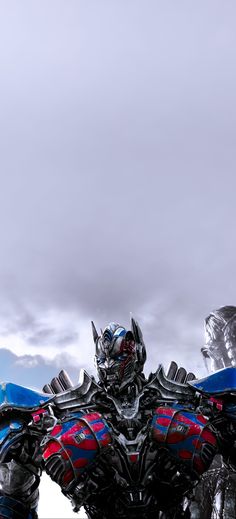 an image of a giant robot that is in the air with clouds behind it,