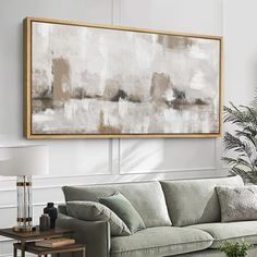 a living room filled with furniture and a large painting hanging on the wall above it