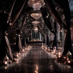 a long aisle with candles and chandeliers on either side, surrounded by black drapes