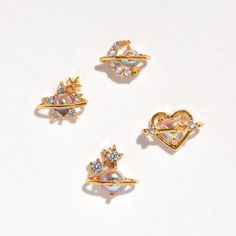 It's easy to get lost in a piece as beautiful as this! Our Universal Love Stud Set features four unique pieces that call back to the beauty of the cosmos. The pearl-like iridescent crystal within each stud is an absolute one-of-a-kind and is sure to become a standout within your collection. Feel like you're unlocking the mysteries of the universe with this set. Earrings Dinosaur, Nail Kits, Dinosaur Earrings, Universal Love, Iridescent Crystal, Tiny Star, Necklace Chain Lengths, Stud Set, The Cosmos