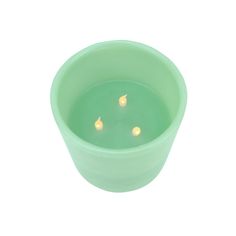 a small green bowl filled with water and lit candles