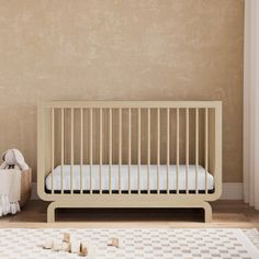 a baby crib in the corner of a room with a checkered rug on the floor