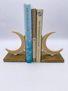 two bookends with books on them sitting next to each other