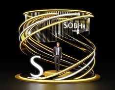 a man standing in front of an illuminated sign with the word sobha on it