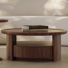 two tables with books on them in front of a couch and coffee table next to each other