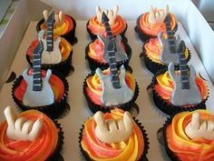 cupcakes decorated like guitars with orange and yellow frosting in a cardboard box