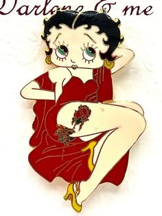 a pin with an image of a woman wearing a red dress and holding her hands behind her head