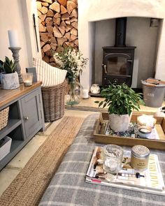 a living room filled with furniture and a fire place next to a wooden burning stove