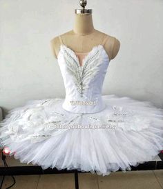 a white tutule dress on display in front of a mannequin