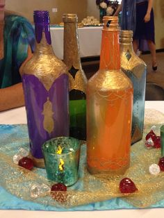 there are many different colored bottles on the table