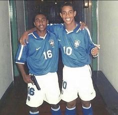 two soccer players are posing for the camera