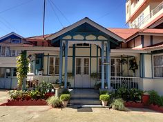 an old house with blue trim and red roof