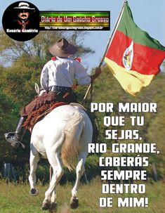 a man riding on the back of a white horse holding a mexican flag in his hand