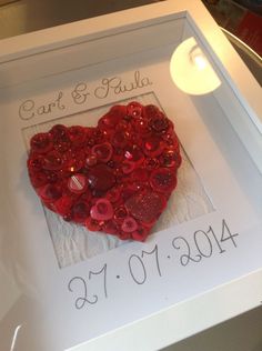 a red heart in a white frame with the words car & julia on it and some buttons