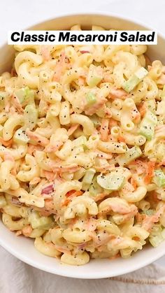 macaroni salad in a white bowl with the words classic macaroni salad