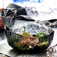 some silver bowls are sitting on a table