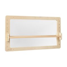 a mirror mounted on the wall with a wooden frame and two mirrors attached to it